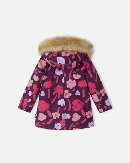 Back view of the deep purple Reima Muurame girls' winter jacket, showcasing the bright floral pattern, attached faux fur hood, and a reflective safety patch near the bottom hem.