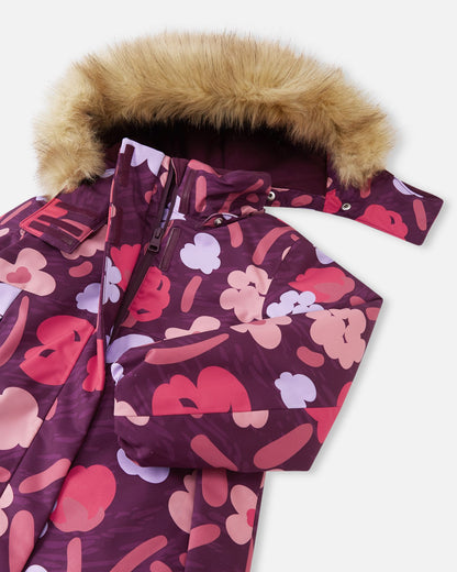 Close-up of the front zipper on the Reima Muurame girls' winter jacket in deep purple, revealing the outer wind flap designed to block cold air and snow from entering.