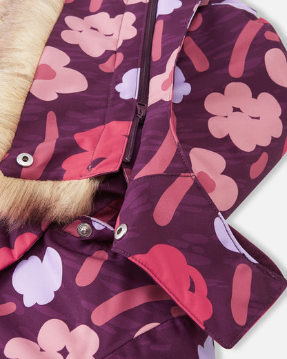 Close-up of the child-safe, detachable hood on the deep purple Reima Muurame winter jacket, showing how it securely fastens to the collar using durable snap buttons.