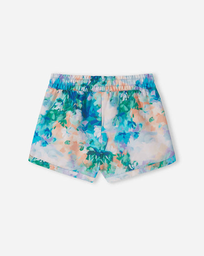 Back view of the fresh blue Reima Nauru girls' UPF 50+ beach shorts, showcasing the continuous watercolor floral pattern, gathered elastic waistband, and quick-drying sunproof fabric.