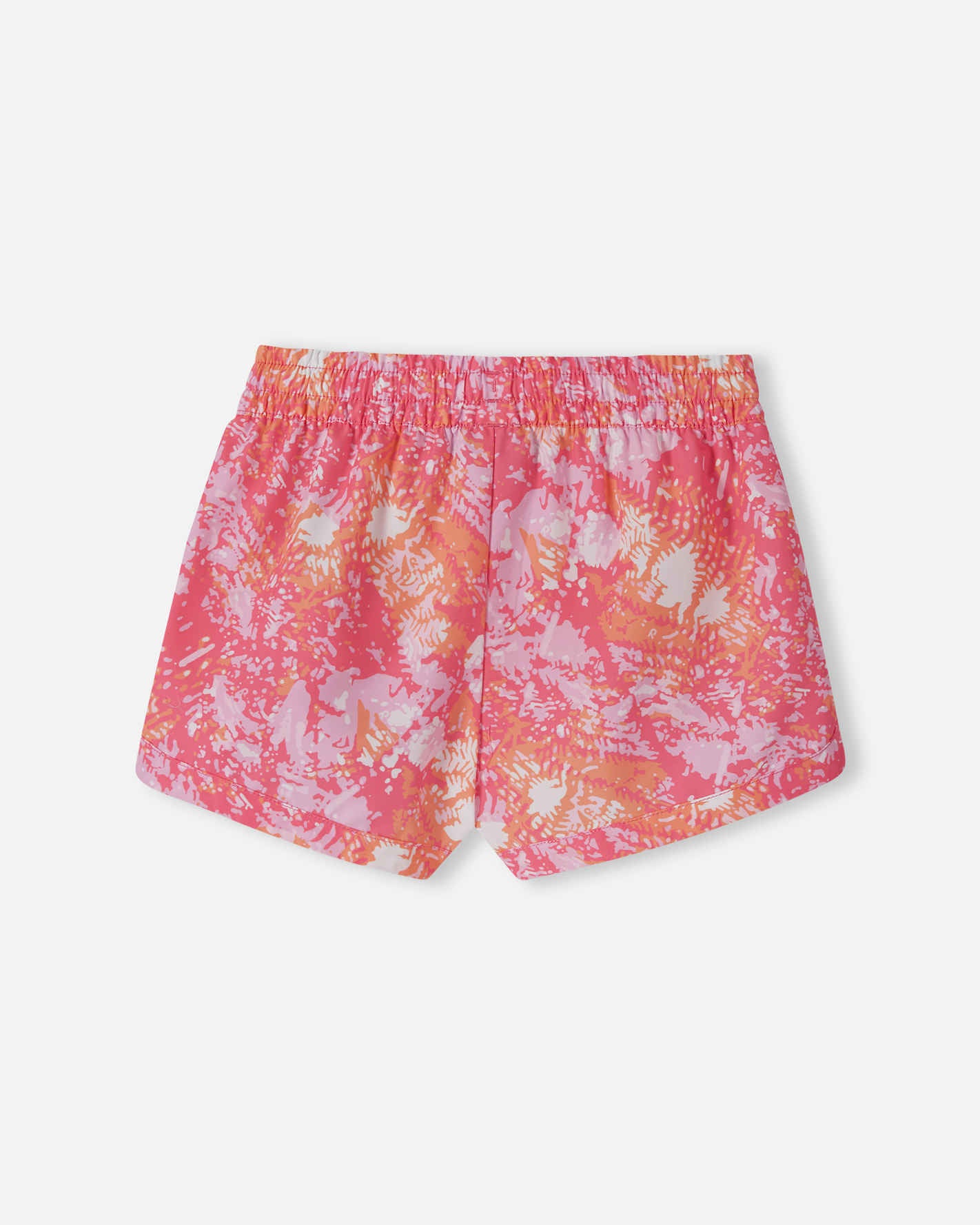 Back view of the soft coral Reima Nauru girls' UPF 50+ board shorts, highlighting the vibrant summer print and comfortable elastic waist designed for active play in the pool or ocean.