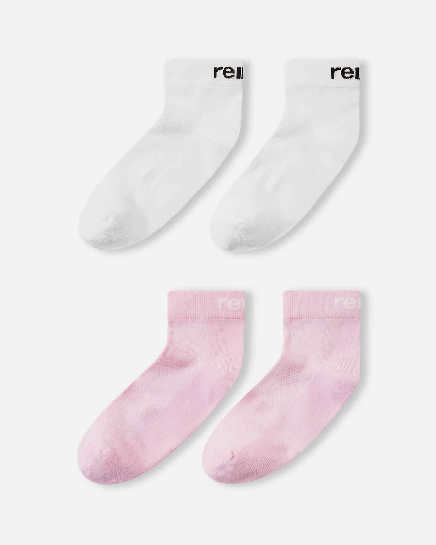 Flat lay view of the Reima Nilkat kids' ankle socks 2-pack, showcasing one pair in a soft light heather pink and one pair in solid white, offering a comfortable and secure fit for active children.