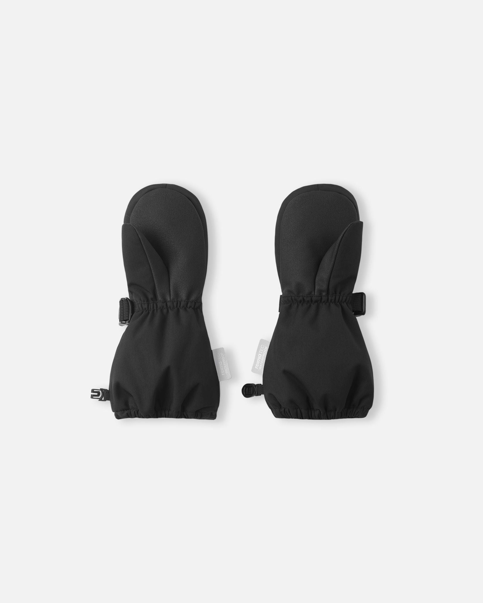 Palm side view of the Reima Ote kids' snow mittens in black, showcasing the heavy-duty reinforced palm and thumb grip designed for holding ski poles and active outdoor winter play.