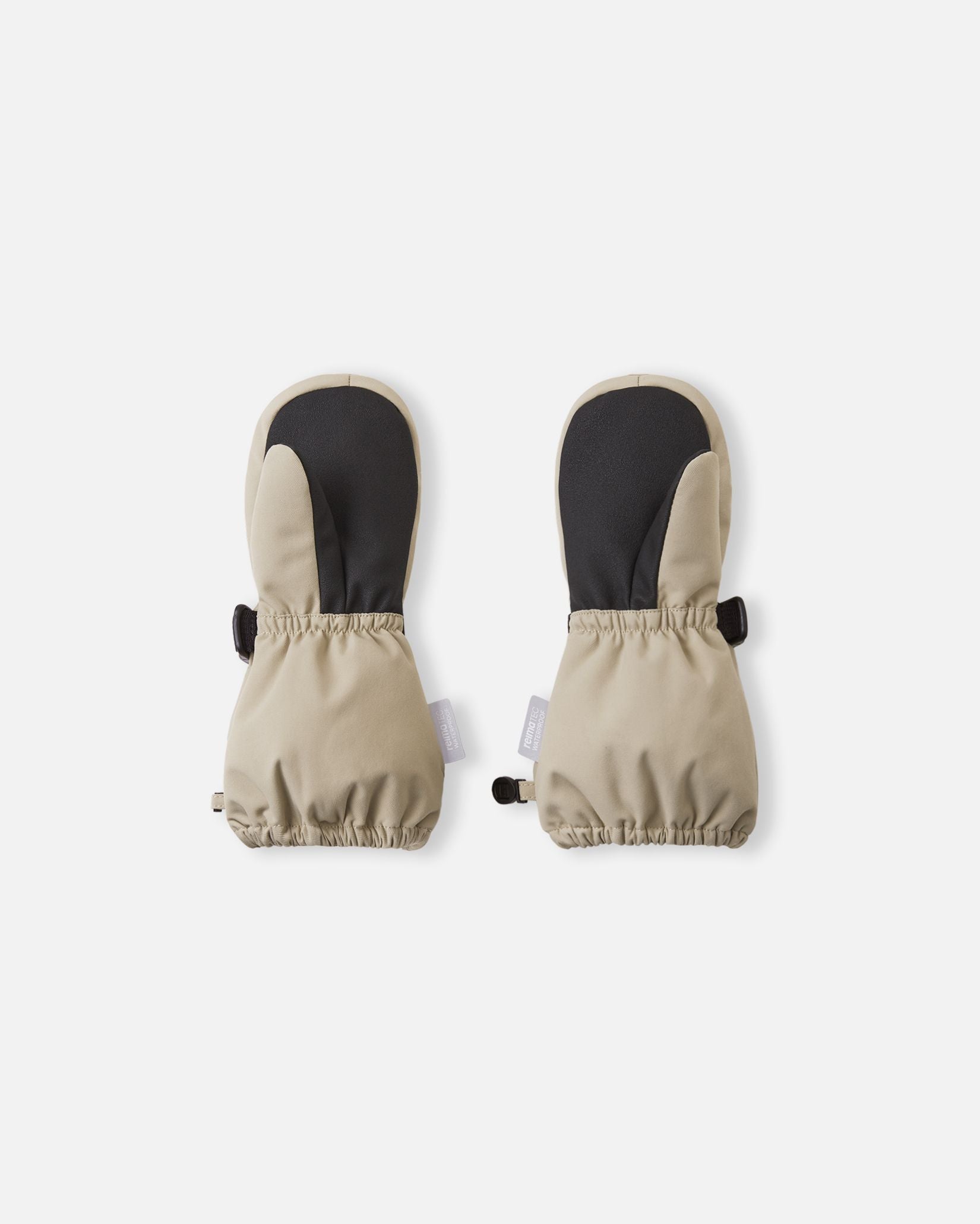 Palm view of the Reima Ote kids' winter mittens in earthy beige, detailing the highly durable black reinforced palm and thumb designed for gripping sleds and playing in harsh winter conditions.