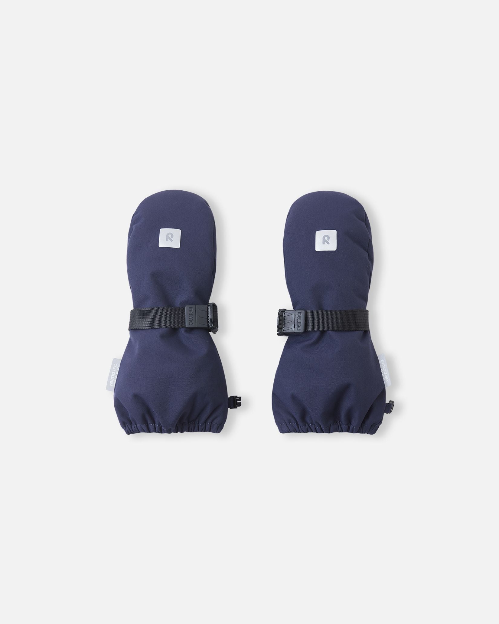 Front top view of the navy blue Reima Ote kids' winter mittens, featuring a highly visible reflective safety logo, a durable waterproof exterior, and a secure adjustable wrist strap to keep snow out.