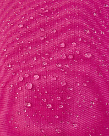 Macro close-up showing water droplets perfectly beading off the vibrant rosy berry Reimatec waterproof fabric of the Reima Ote kids' winter mittens.