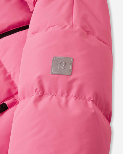 Close-up of the sleeve on the soft coral pink Reima Paimio children's puffer coat, highlighting the square reflective Reima 'R' logo patch that enhances visibility during dark winter days.