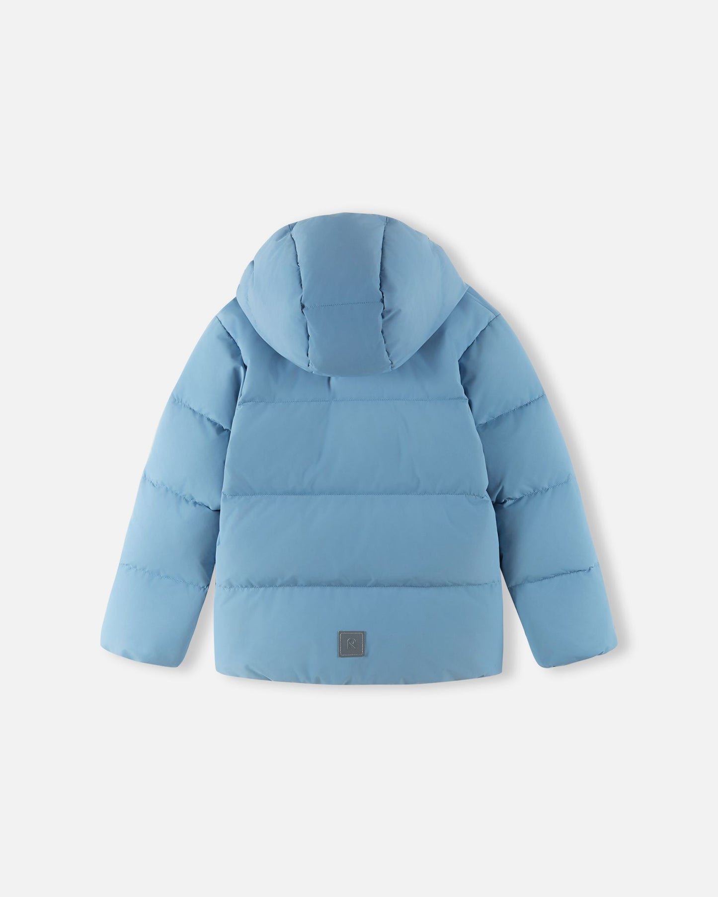 Back flat lay view of the Reima Paimio children's winter down puffer jacket in cloudy blue with the hood attached, showcasing the insulated quilted design and a reflective safety patch near the lower hem.