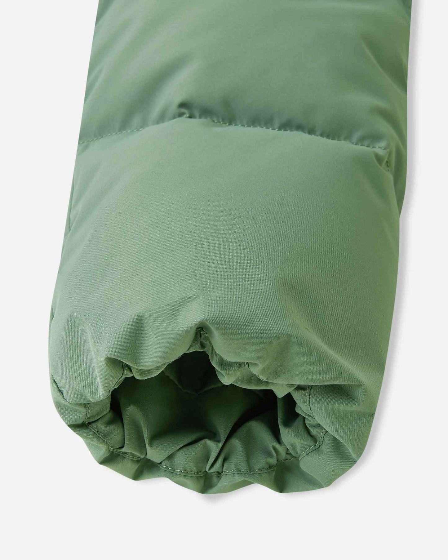 Detail shot of the sleeve opening on the green clay Reima Paimio kids' warm jacket, showcasing the stretch elastic cuff designed to trap body heat and block cold air.