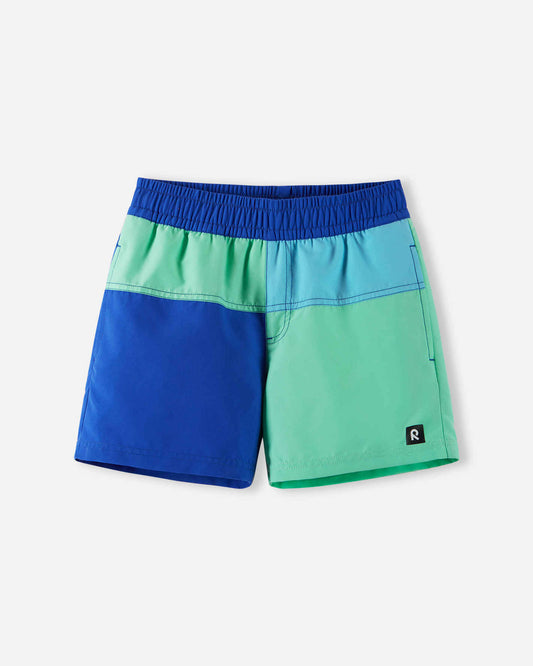 Front view of the Reima Palmu kids' UPF 50+ sunproof swim shorts in a vibrant sparkly blue and mint green color block design, engineered with high-level UV-protective fabric for safe summer swimming.