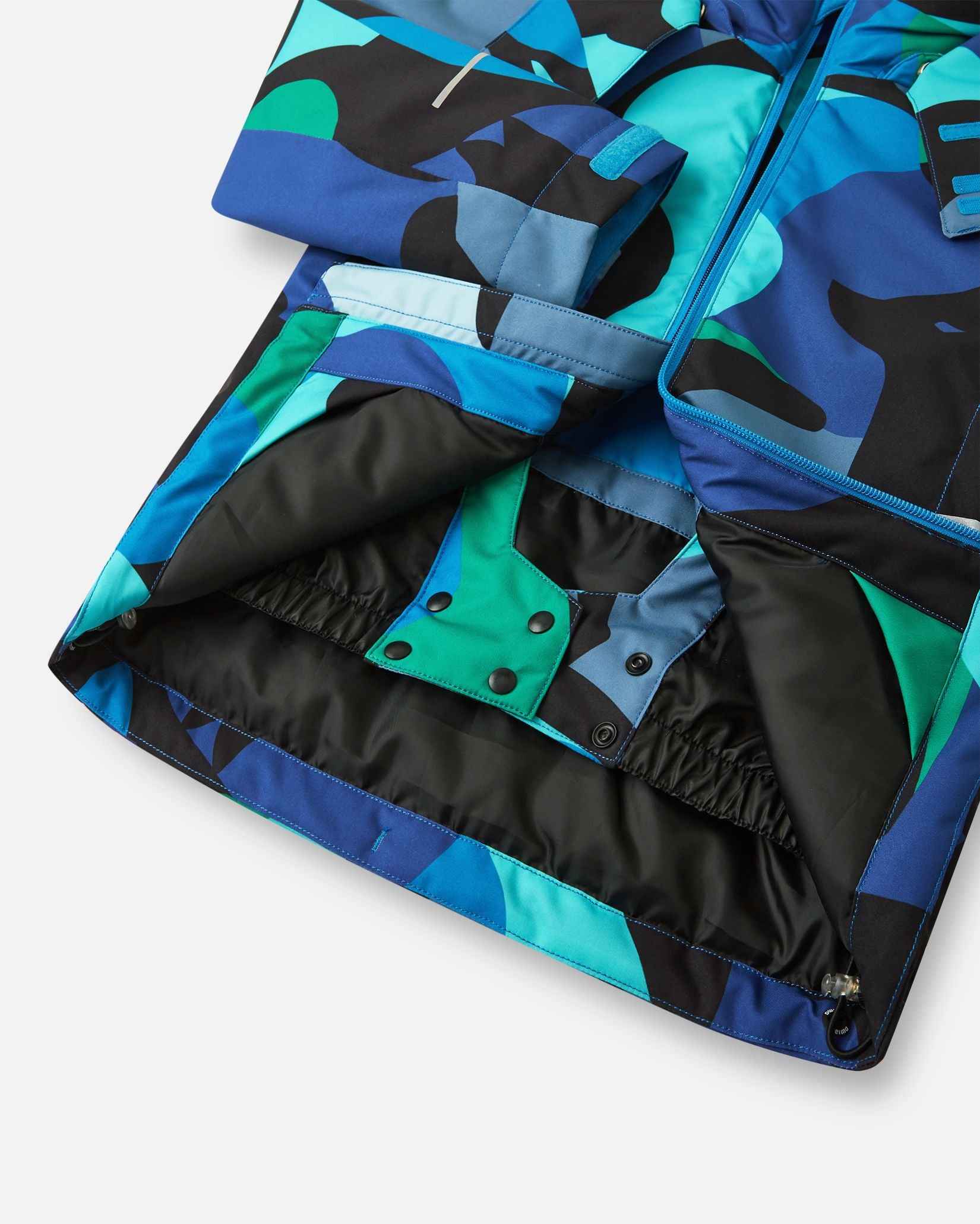 The back of the aquatic patterned kids coat folded to display the blue and black abstract shapes.