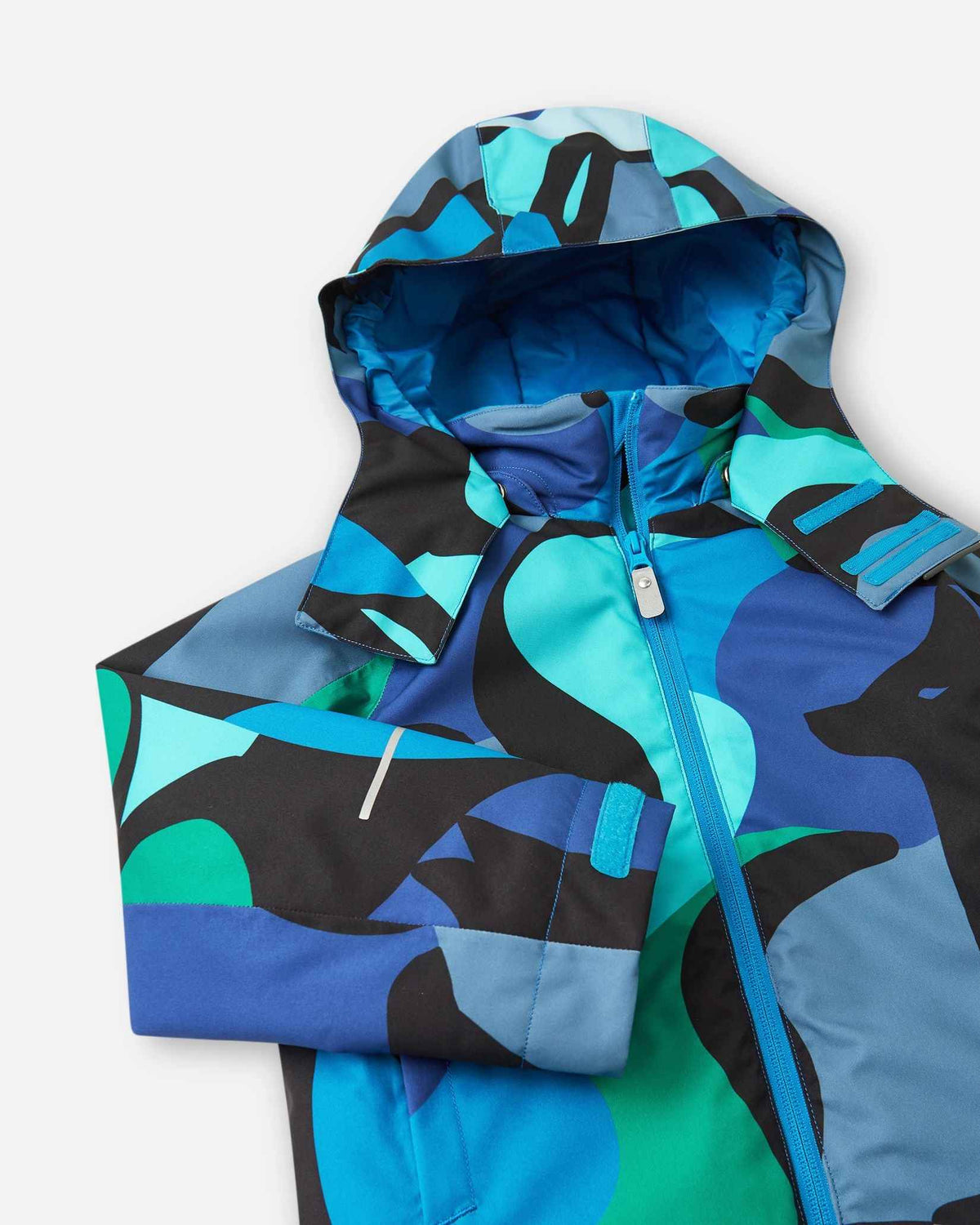 A full front view of the Reima Palsi ski jacket in the blue aquatic camo pattern with the hood attached.