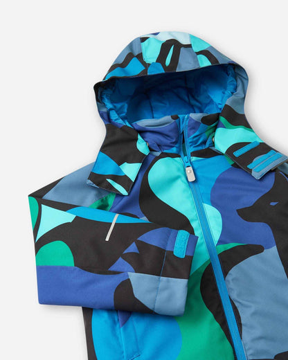 A full front view of the Reima Palsi ski jacket in the blue aquatic camo pattern with the hood attached.