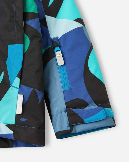 A close-up of the cuff on a kids' ski jacket, showing off the cool aquatic pattern of abstract blue, black, and teal shapes.