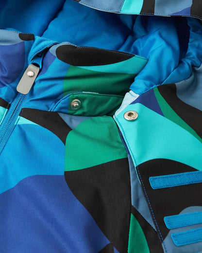Close-up fabric detail showing the colorful geometric aquatic pattern on the Reima Palsi Ski Jacket.