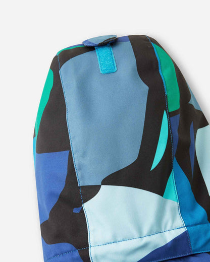 Detail view of the sleeve on the Reima Palsi Ski Jacket in the Aquatic colorway, showing the bright geometric design.