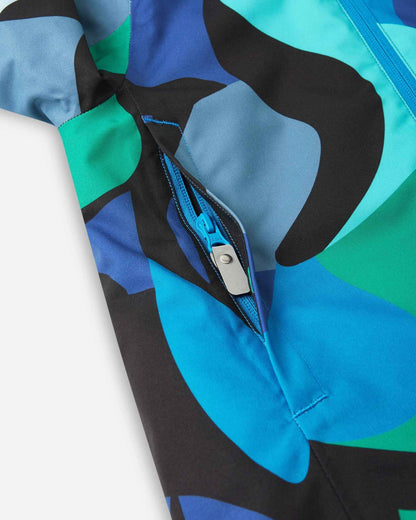 A close view of a dark blue zipper on the aquatic patterned ski jacket.