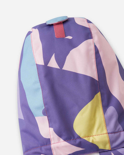 The back of the blooming lilac kids coat is folded flat to display the pink and purple shapes.
