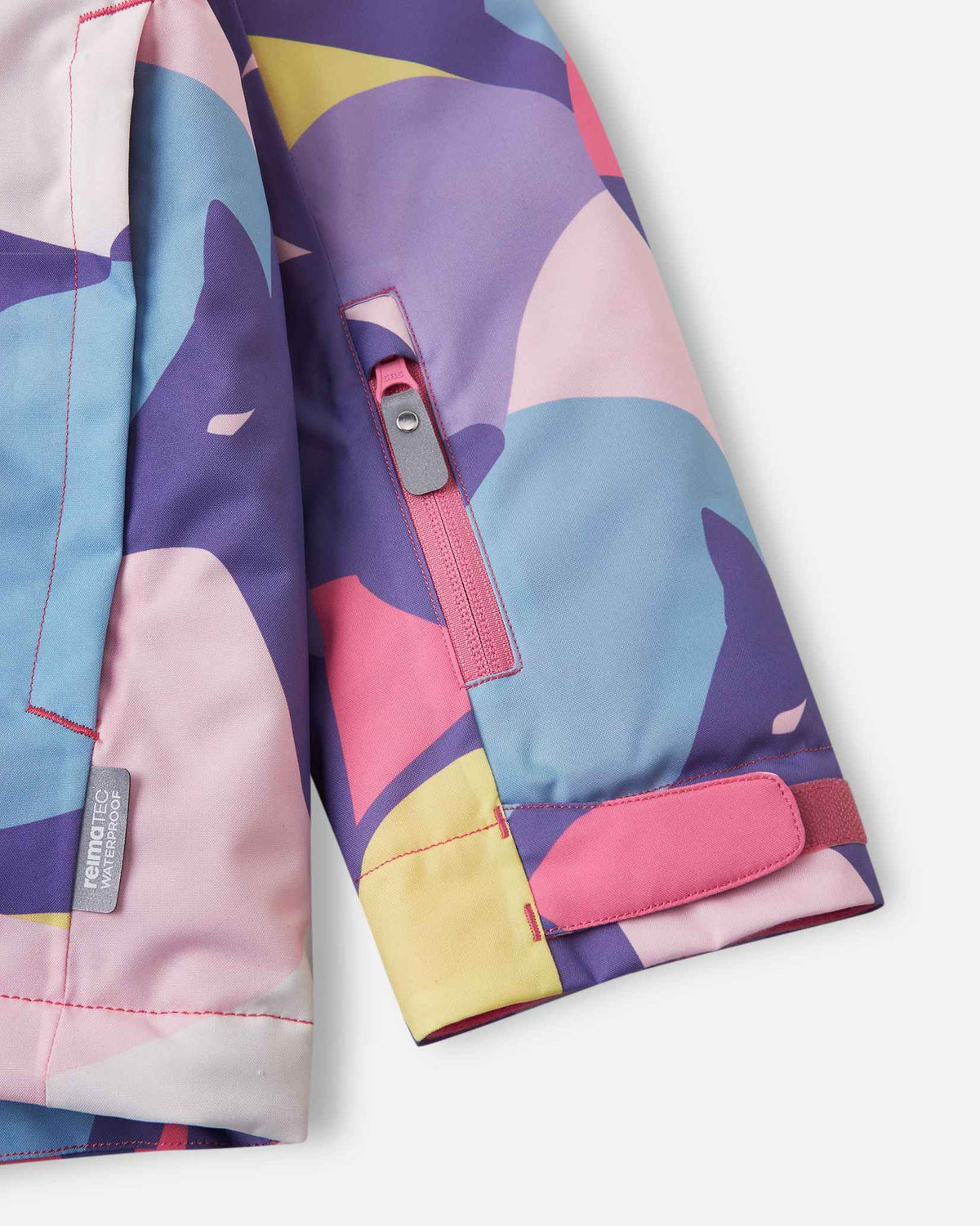 Close-up view of the adjustable cuff and patterned pink and purple sleeve on the Blooming Lilac Reima Palsi Ski Jacket.