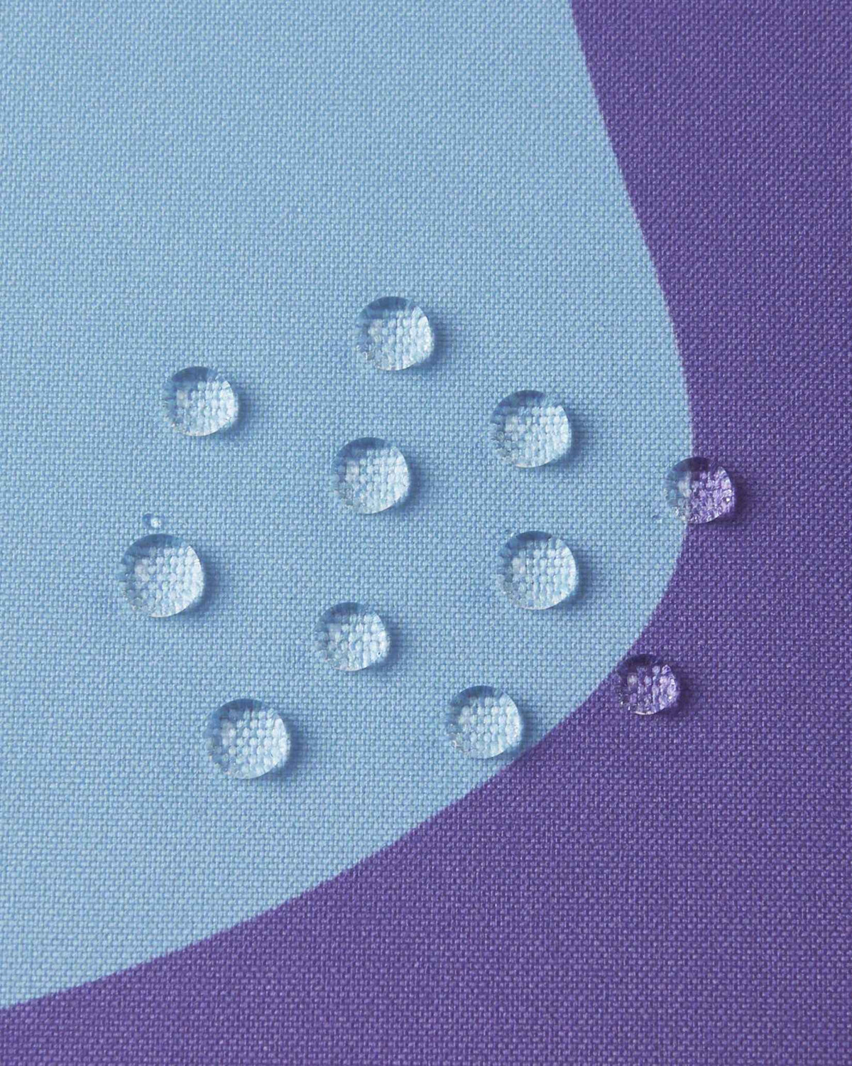 Water droplets beading on the solid Blooming Lilac purple fabric of the Reima Palsi Ski Jacket, showcasing its water-repellent features.