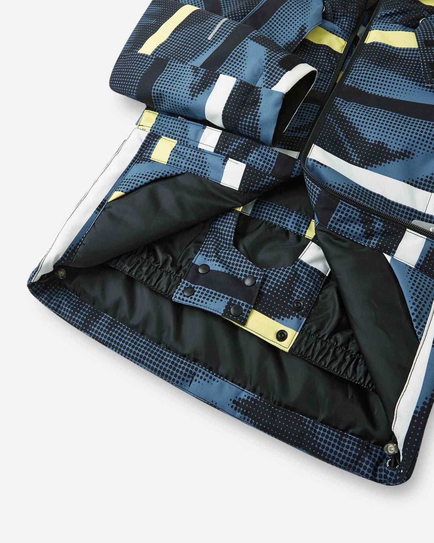 A close-up view of the inner black snow skirt and snap buttons on the Blue Ocean Reima Palsi ski jacket.