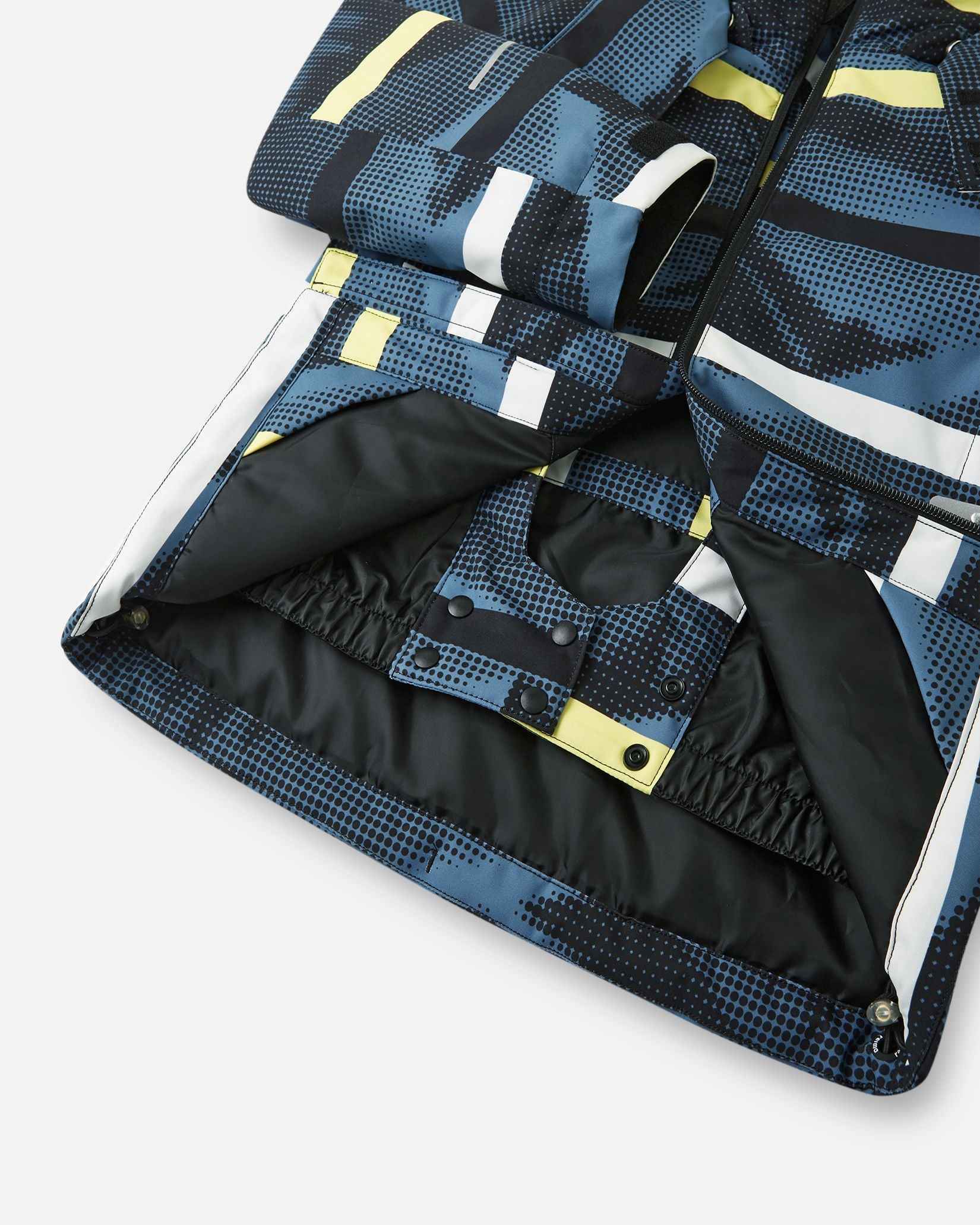 A close-up view of the inner black snow skirt and snap buttons on the Blue Ocean Reima Palsi ski jacket.