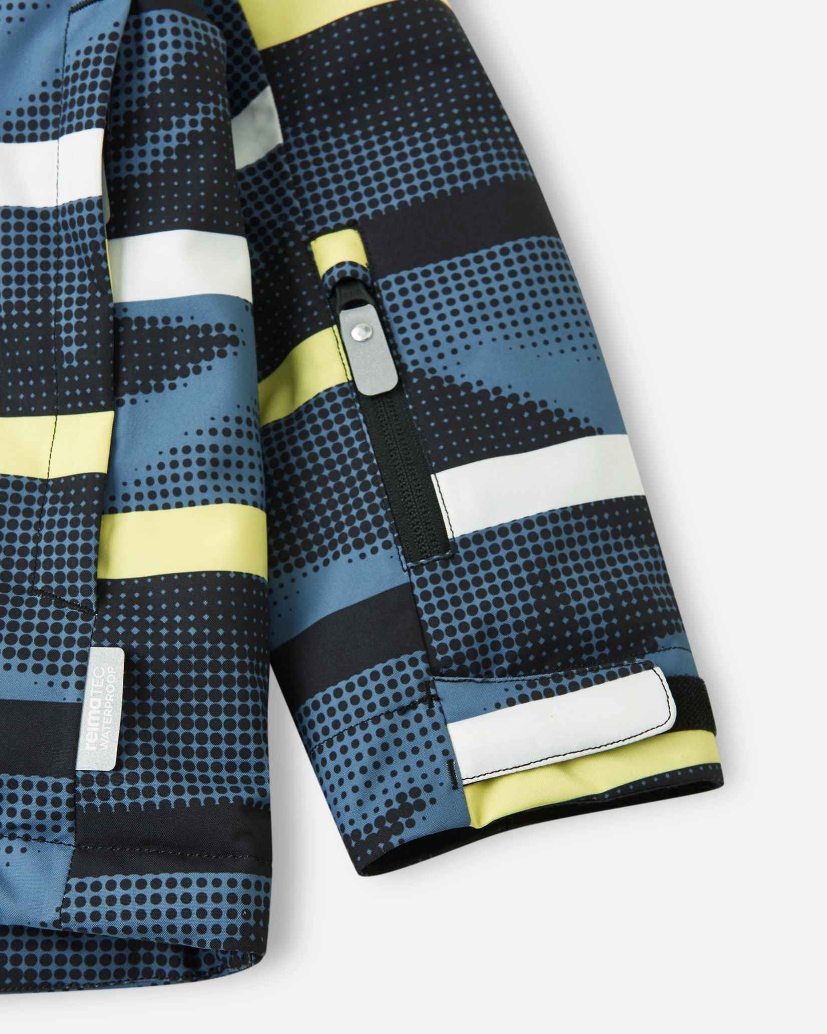 A close-up of the sleeve on the Blue Ocean Reima Palsi ski jacket showing a zippered pocket and a hook-and-loop adjustable cuff.