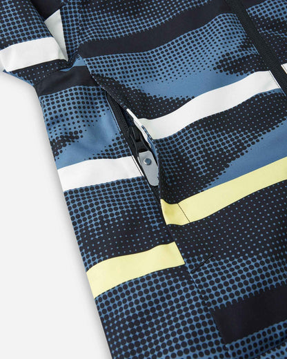 A close view of the pocket on the Blue Ocean Reima Palsi ski jacket showing the yellow and white stripe pattern.