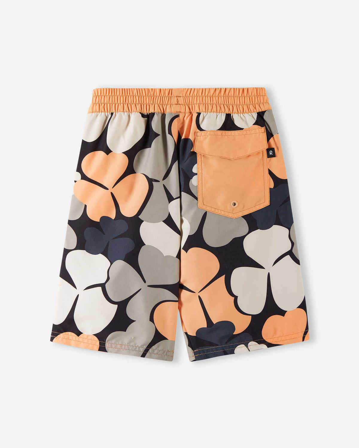 Back view of the apricot Reima Papaija boys' UPF 50+ board shorts, highlighting a solid apricot flap pocket on the back with a water drainage eyelet, set against a bold floral pattern.