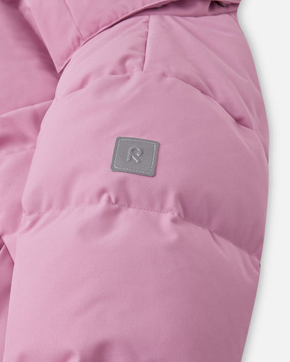 Close-up of the quilted puffy sleeve on the grey pink Reima Parkkala youth longline jacket, featuring the square high-visibility reflective Reima 'R' logo patch for enhanced safety during dark winter afternoons.