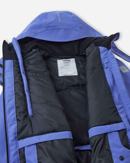 Interior view of the Reima Perille kids' ski jacket, revealing the smooth lining, internal chest pocket, and the integrated powder skirt with a jacket-to-pants connector to keep out loose snow.