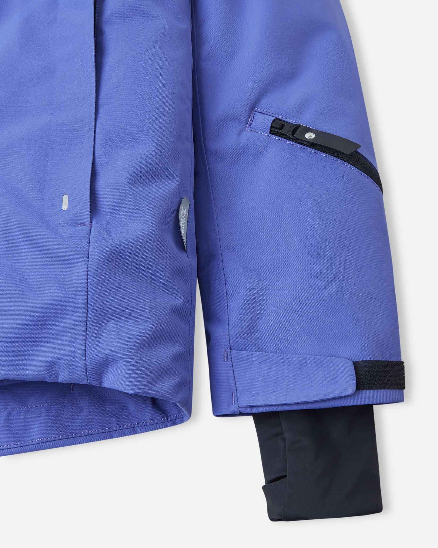 Detailed view of the lower sleeve on the breezy violet Reima Perille youth ski coat, showcasing the secure zippered ski pass pocket, adjustable hook-and-loop cuff, and the inner lycra wrist gaiter with a thumbhole to keep snow out of gloves.
