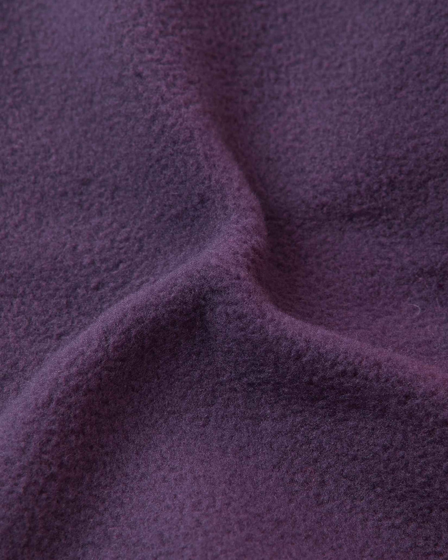 Close-up of the soft dark purple thermal fleece lining inside the Reima Pohjoinen kids' merino wool beanie, engineered for itch-free comfort, wind resistance, and maximum heat retention.