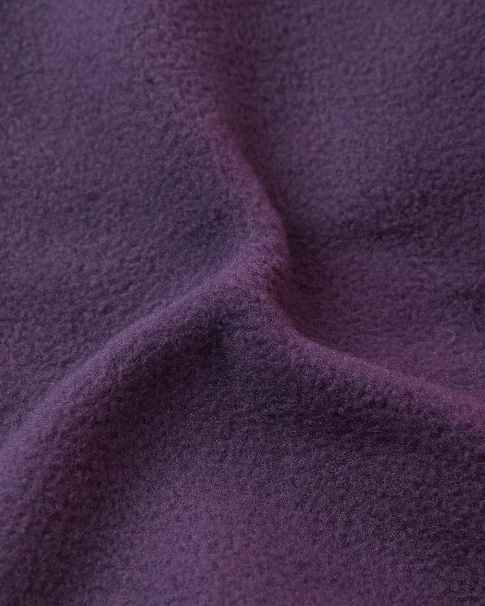 Close-up of the soft dark purple thermal fleece lining inside the Reima Pohjoinen kids' merino wool beanie, engineered for itch-free comfort, wind resistance, and maximum heat retention.