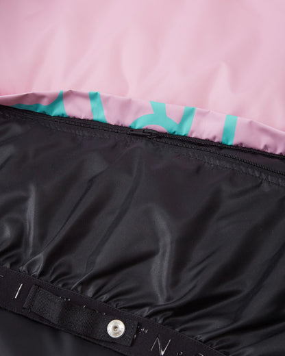 Interior detail of the Reima Posio girls' ski jacket, showing the internal zipper mechanism that allows the waist snow lock powder skirt to be completely detached from the black inner lining.