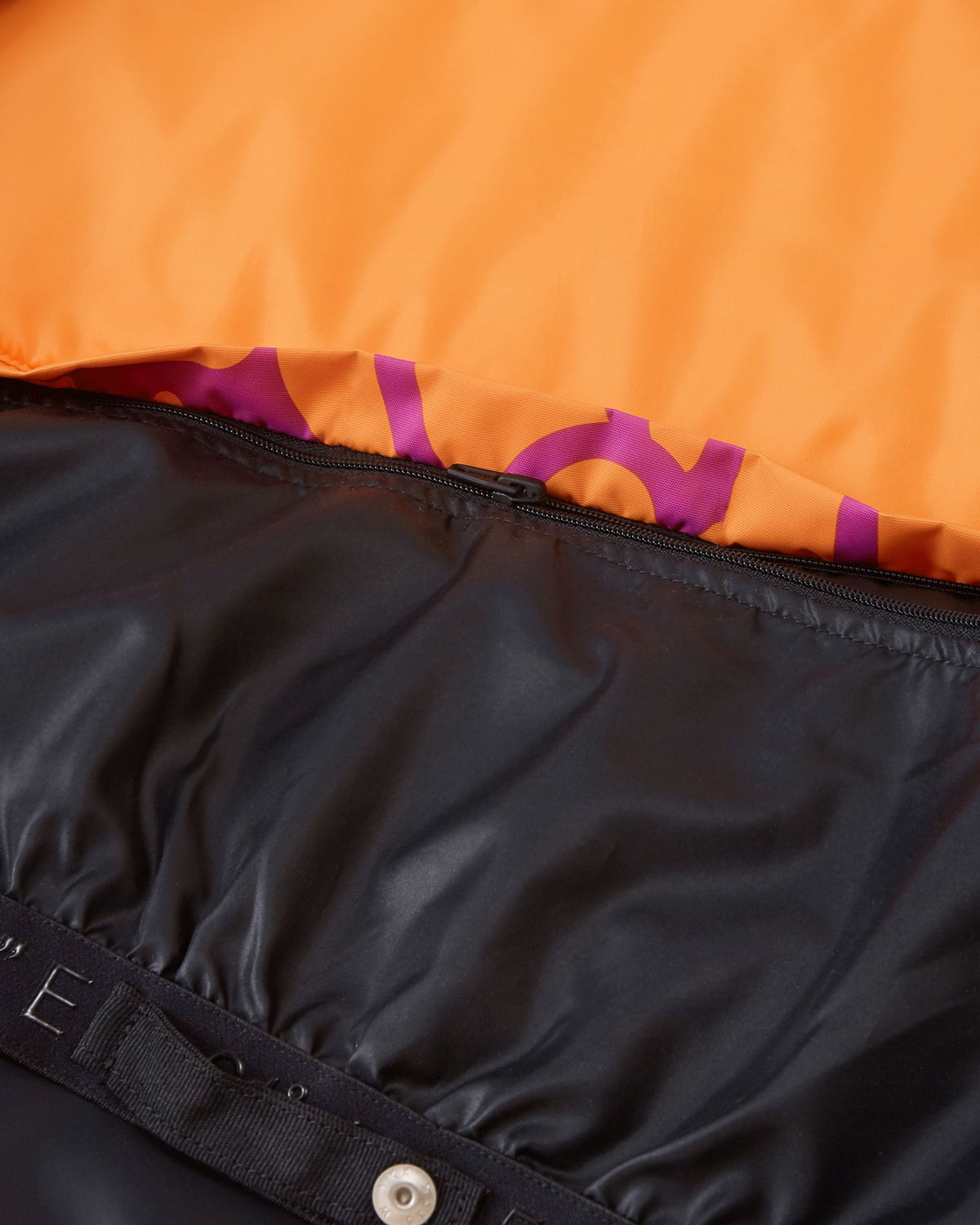 Interior detail of the Reima Posio girls' ski jacket, showing the internal zipper mechanism that allows the waist snow lock powder skirt to be completely detached from the black lining
