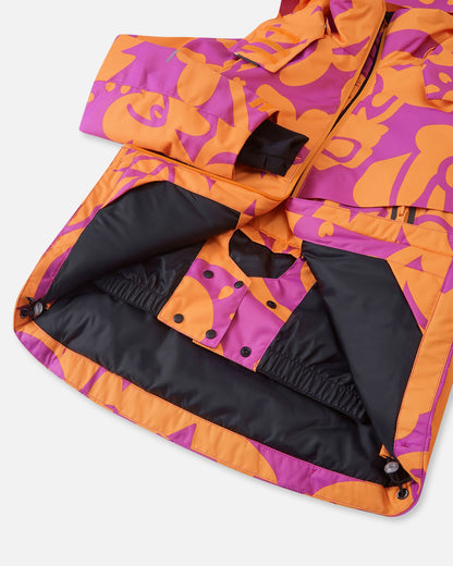 Interior view of the Reima Posio girls' ski jacket, revealing the smooth black lining, adjustable hem cords, and the built-in snap-button snow lock powder skirt designed to keep snow out.