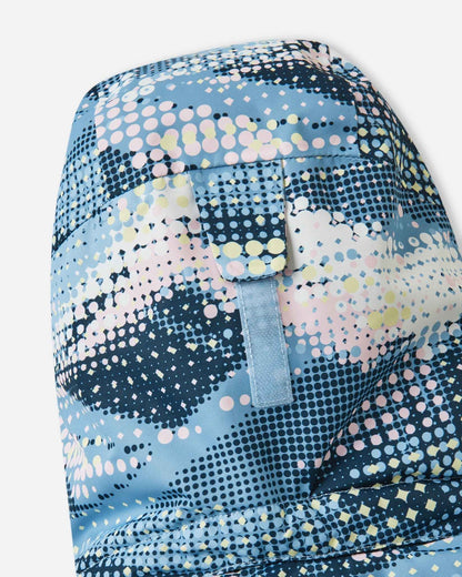 Close-up view of the adjustable velcro strap on the back of the helmet-compatible hood of the frozen blue Reima Posio kids' waterproof winter ski jacket.
