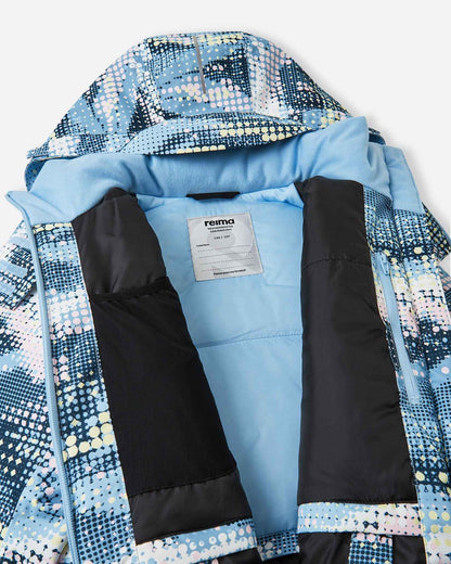 Inside view of the frozen blue Reima Posio kids' waterproof ski jacket, showing the smooth blue winter lining, internal mesh goggle pocket, zippered chest pocket, and Reima name tag.