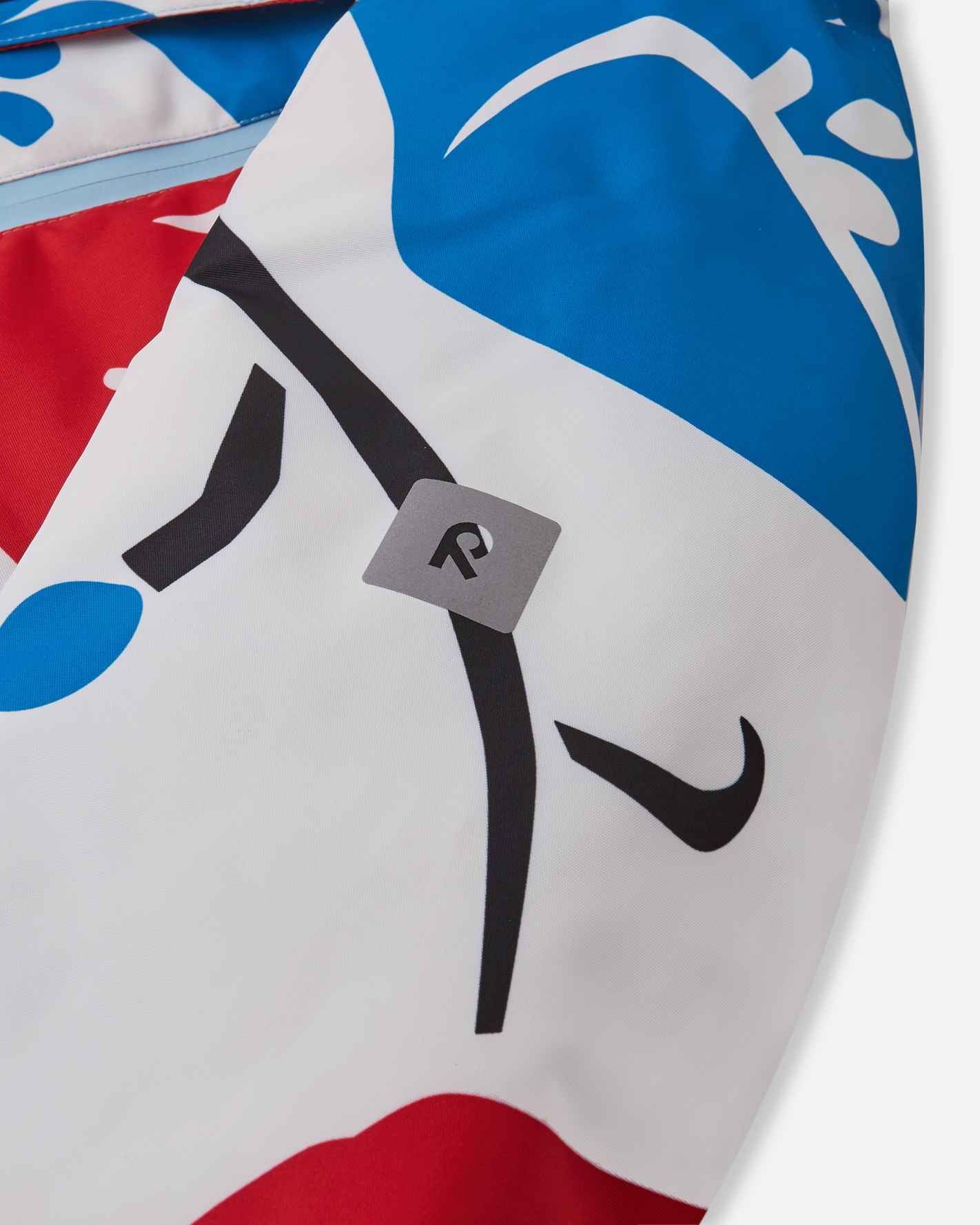 Close-up of the safety-enhancing reflective Reima logo patch on the sleeve of the white Posio kids' waterproof ski jacket, providing visibility in low-light conditions.
