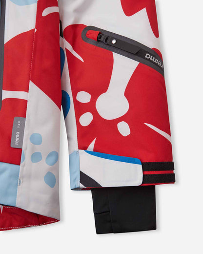 Close-up of the lower sleeve on the white Reima Posio kids' ski jacket, highlighting the waterproof zippered ski pass pocket, adjustable velcro cuff, inner lycra thumbhole cuff, and Reimatec tag.