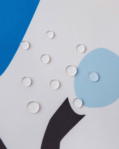 Macro close-up of water droplets perfectly beading on the surface of the white Reima Posio kids' ski jacket, demonstrating the high-performance waterproof and breathable Reimatec outer fabric.