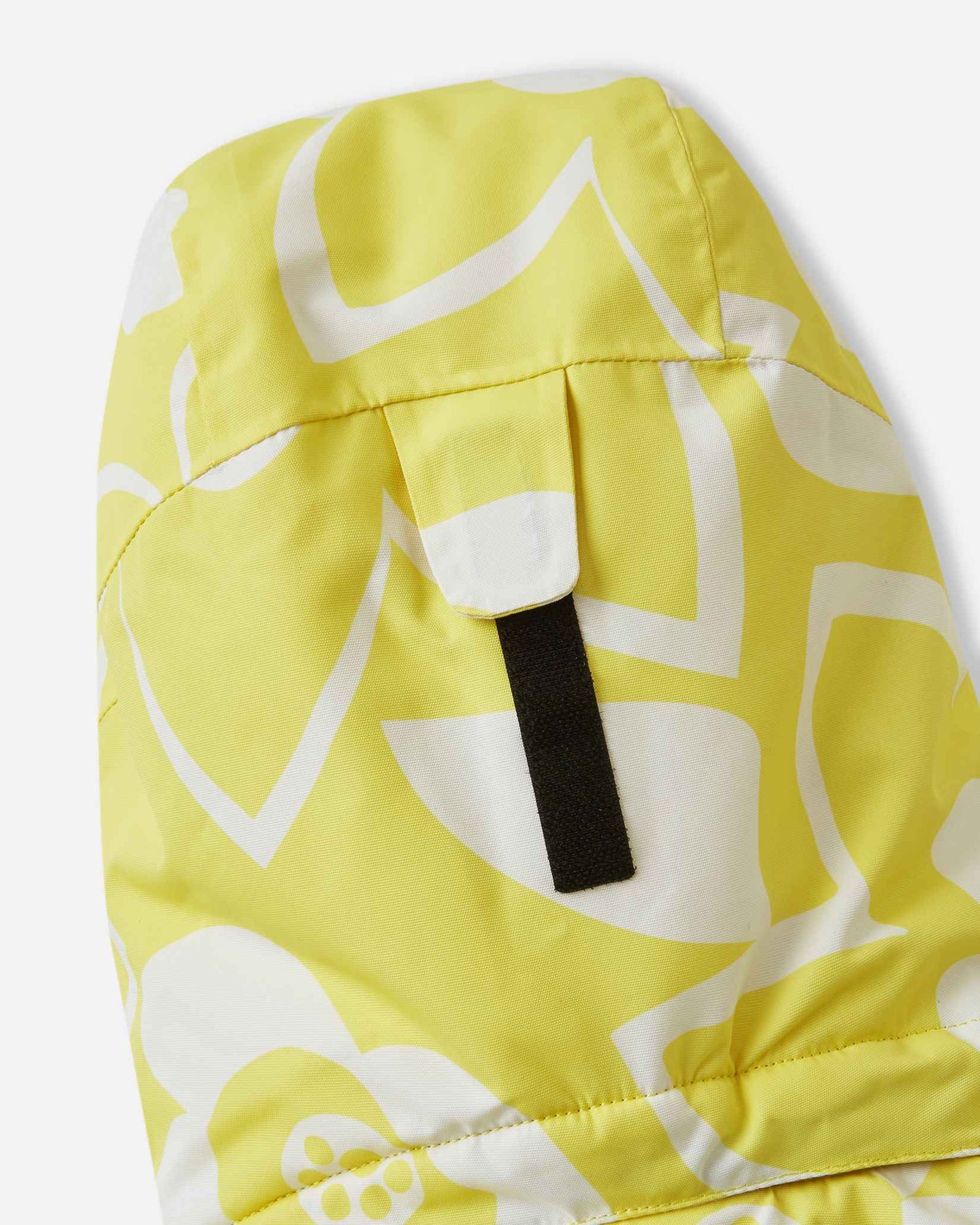 Close-up view of the adjustable velcro strap on the back of the helmet-compatible hood of the yellow Reima Posio kids' waterproof winter ski jacket.