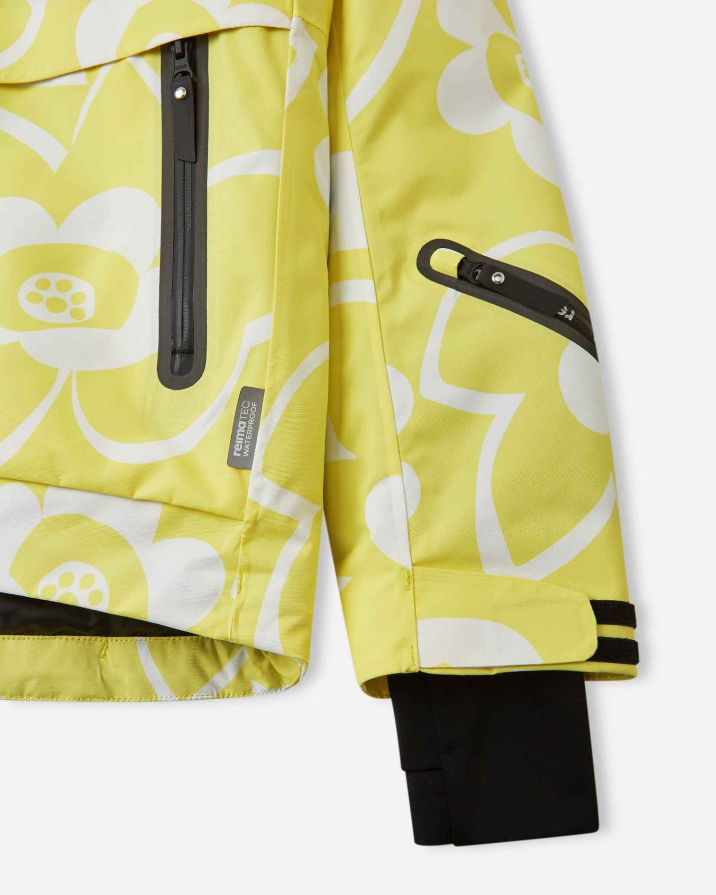 Detail view of the waterproof zippered sleeve ski pass pocket, velcro cuff adjuster, and inner lycra cuff with thumbhole on the yellow Reima Posio kids' ski jacket.
