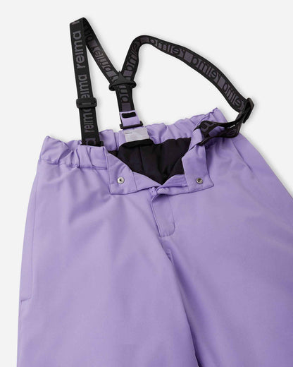 Close-up detail of the front waist on the blooming lilac Reima Proxima kids' ski pants, showing the secure snap buttons, smooth zipper fly, elastic back waistband, and adjustable branded suspenders.