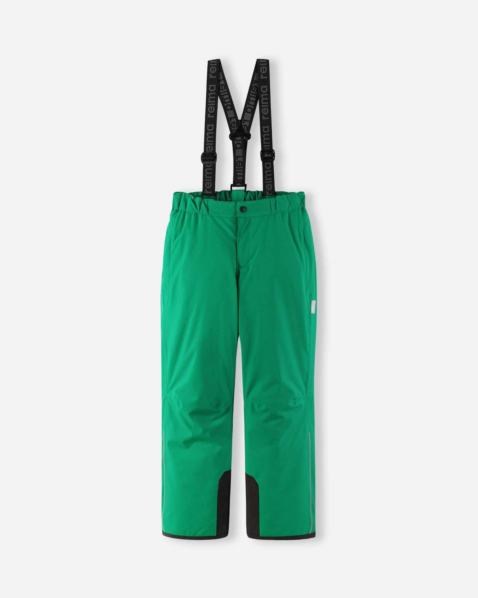 Front flat lay view of the bright green Reima Proxima kids' winter ski pants, featuring adjustable Reima-branded black suspenders, a zippered fly, and durable black reinforced hems designed for alpine skiing.