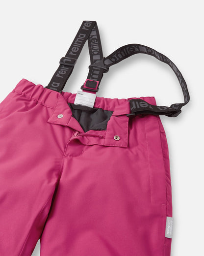Close-up detail of the front waist on the rosy berry Reima Proxima kids' ski pants, showing the secure snap buttons, smooth zipper fly, elastic back waistband, and adjustable branded suspenders.