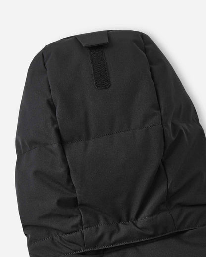 Close-up of the back of the insulated hood on the black Reima Ranua kids' down ski jacket, detailing the velcro adjustment tab used to customize the fit for maximum warmth and visibility.