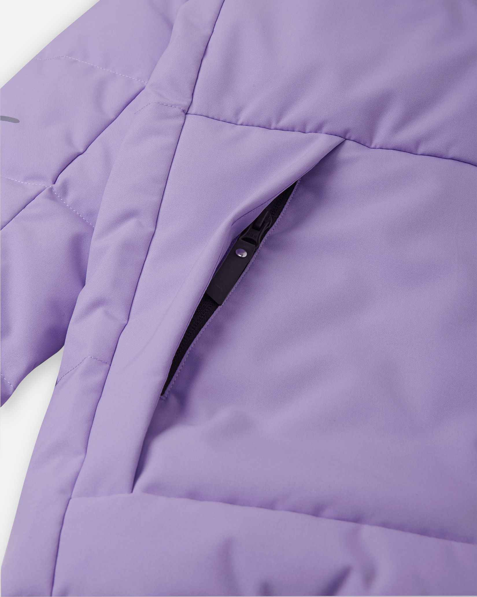 Close-up detail of the secure, hidden front zippered pocket on the quilted blooming lilac body of the Reima Ranua kids' down ski jacket, perfect for safely storing small items during outdoor winter play.