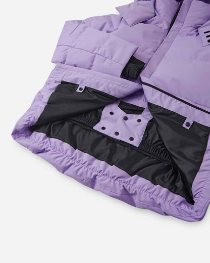 Interior view of the lower half of the blooming lilac Reima Ranua kids' down ski jacket, featuring a smooth black lining, an adjustable elastic hem, and a built-in snow skirt with snap fasteners to completely block out snow and cold drafts.